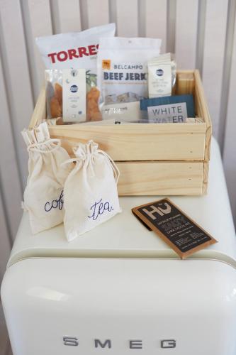 a wooden crate filled with products on top of a bed at White Water in Cambria