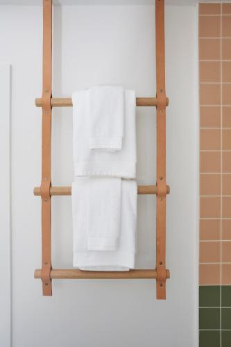 a towel rack in a bathroom with white towels at White Water in Cambria