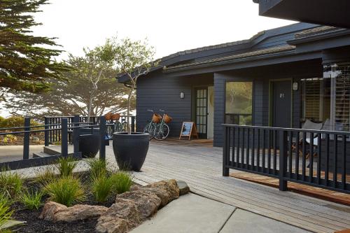 a porch of a house with a fence and plants at White Water in Cambria