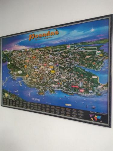 a poster of a city on a wall at Hotel Residencial Marlis in Posadas