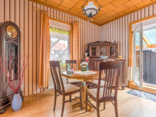a dining room with a wooden table and chairs at Apartment in Ilsenburg near the ski area in Ilsenburg