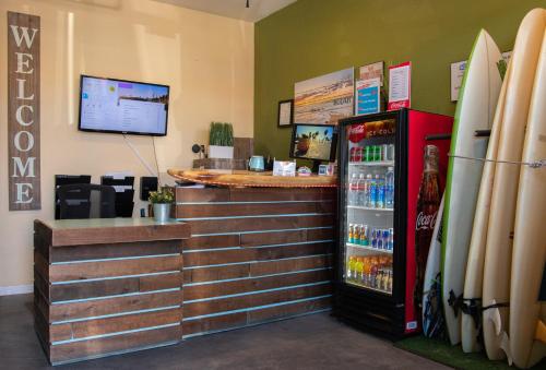 a store with a counter and a drink refrigerator at California Dreams Hostel - Pacific Beach in San Diego