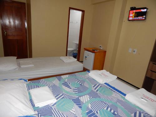 Habitación pequeña con 2 camas y TV. en Miraserra en Ubajara