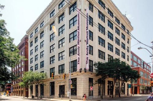 a large white building on a city street at Abode Pittsburgh - Downtown Convention Center in Pittsburgh