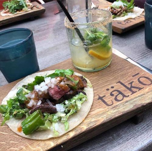 a plate of food with a taco and a drink at Abode Pittsburgh - Downtown Convention Center in Pittsburgh