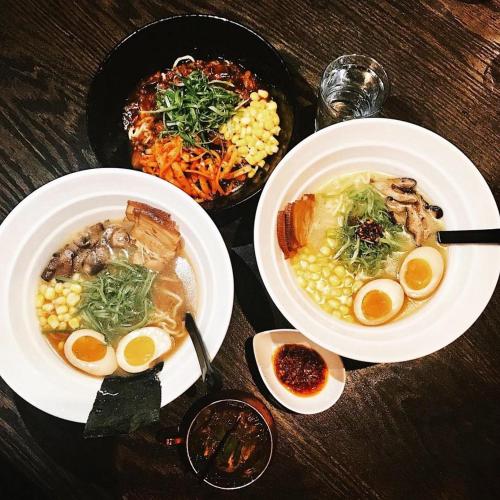 a table with two bowls of soup and a plate of food at Abode Pittsburgh - Downtown Convention Center in Pittsburgh
