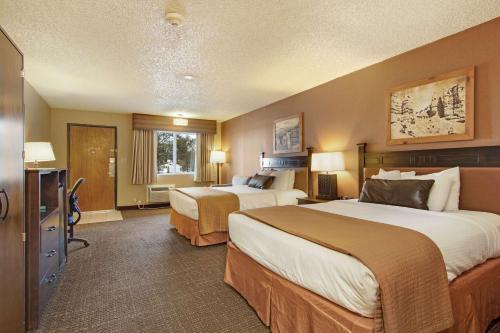 a hotel room with two beds and a television at Best Western PLUS Ruby's Inn in Bryce Canyon