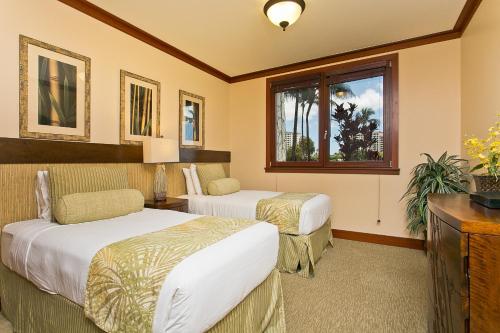 a hotel room with two beds and a window at Ground floor unit with Private Garden in Kapolei