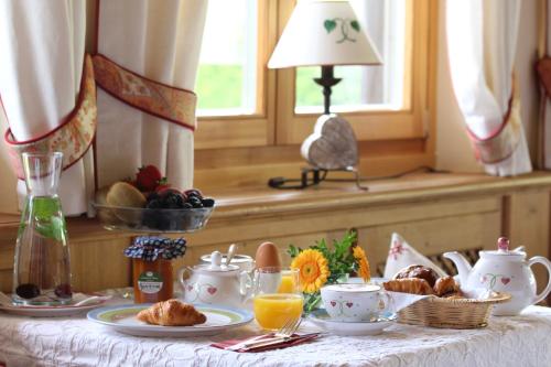 a table with a breakfast of eggs and coffee on it at Landhaus am Stein in Bad Wiessee