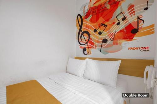 a bedroom with a bed with music notes on the wall at Tamansari Agung Residence in Jakarta