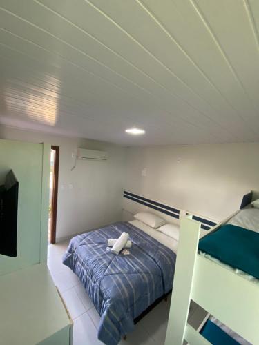 a bedroom with a bed and a tv in it at Pousada Coração do Parque in Penha