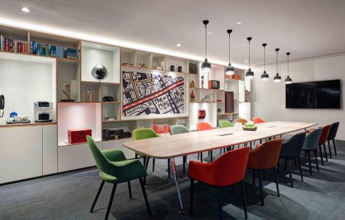 a dining room with a large wooden table and chairs at YaTi by Artyzen Hongqiao Shanghai - Korean Street in Shanghai