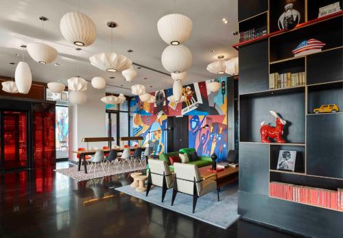 a living room with couches and chairs and a mural at YaTi by Artyzen Hongqiao Shanghai - Korean Street in Shanghai