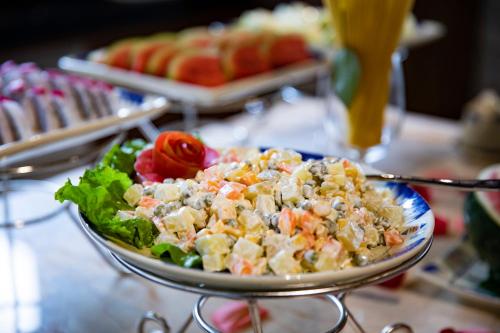 a salad in a bowl on a table at Sapa Catcat Hills Resort & Spa in Sa Pa