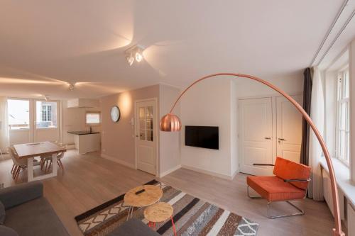 a living room with a couch and a table at Residences Jordan 9 Streets in Amsterdam