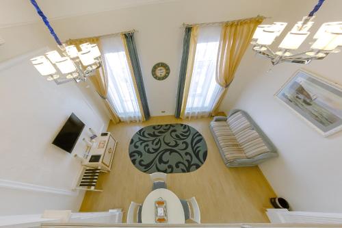 a view of a living room with a table and windows at Metro Hotel Apartments in Odesa