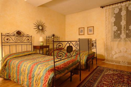 a bedroom with a bed and two chairs in it at Azienda Agricola Palazzo Manzoni in San Zaccaria