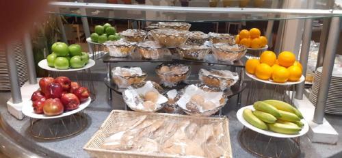 a display of fruits and vegetables on plates on a counter at Holiday Inn Olaya by IHG in Riyadh