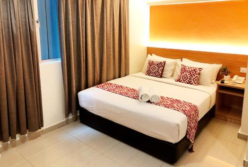 a hotel room with a large bed and a large window at Easy Hotel KL Sentral in Kuala Lumpur