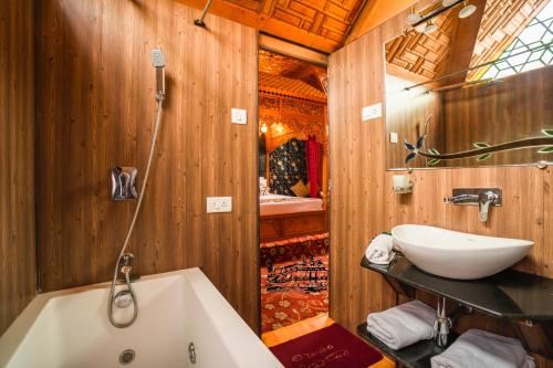 a bathroom with a bath tub and a sink at New Jacquline Heritage Houseboats in Srinagar