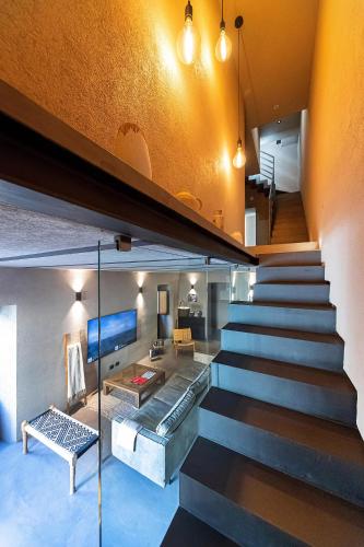 a staircase in a house with a living room at Casa Nostra Luxury Suites & Spa in Palermo