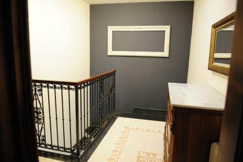 a hallway with a staircase with a mirror on the wall at Sa Mola in Bonarcado