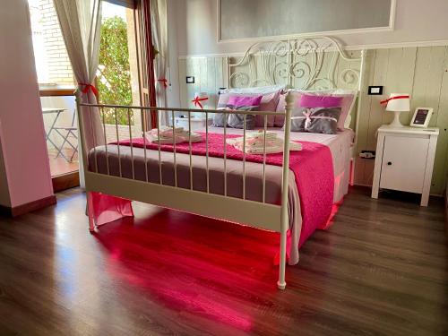 a bedroom with a large bed with a pink blanket at Sweet Rome B&B in Rome