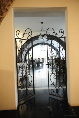 an open gate to a dining room with tables at Sa Mola in Bonarcado