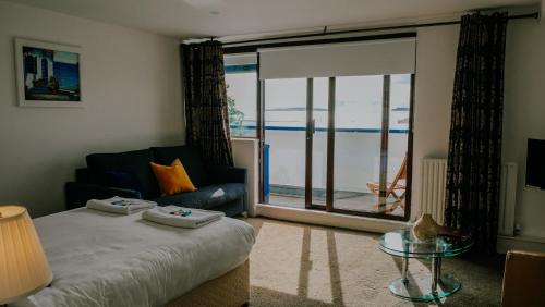 a bedroom with a bed and a view of the ocean at The Wooden House - Room Only Accomodation in Kilmore Quay