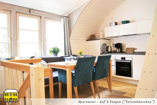 a kitchen and dining room with a table and chairs at Das Gelbe Haus - Drei besondere Ferienwohnungen in Flensburg