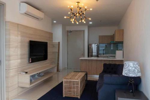 a living room with a blue couch and a television at PINTARMAN SUITES @ MIRI TIMES SQUARE in Miri