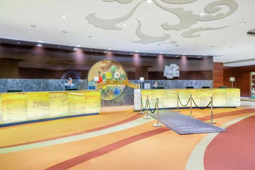 a lobby with a bowling court and a person in a gym at Holiday Inn Nanjing Aqua City by IHG in Nanjing