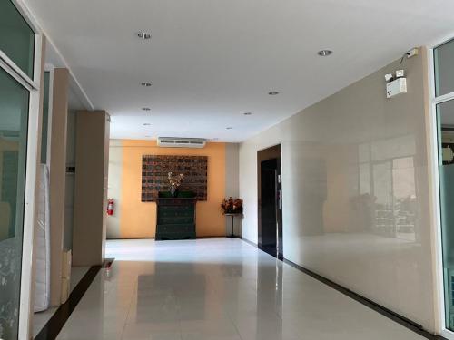 a hallway of a building with a brick wall at LeeNova Place in Ban Khlong Prawet