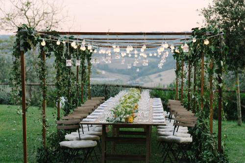 a long dining table with chairs and lights at Villa S.Andrea in San Casciano in Val di Pesa