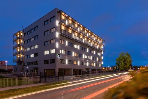 a white building with lights on the side of a street at U11 Hotel & SPA in Tallinn