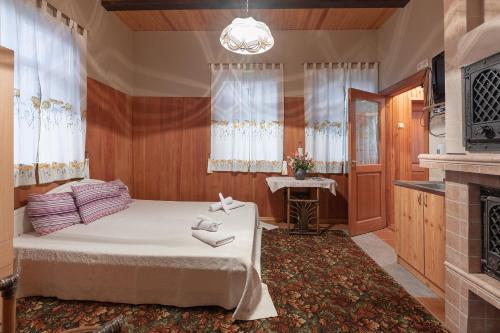 a bedroom with a bed and a fireplace at Valensija in Jūrmala