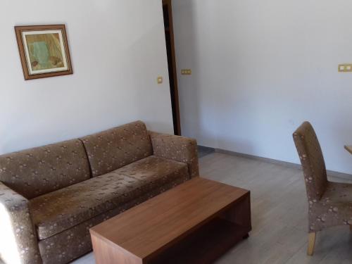 a couch and a chair in a room at Apartment Nice View in Fojnica