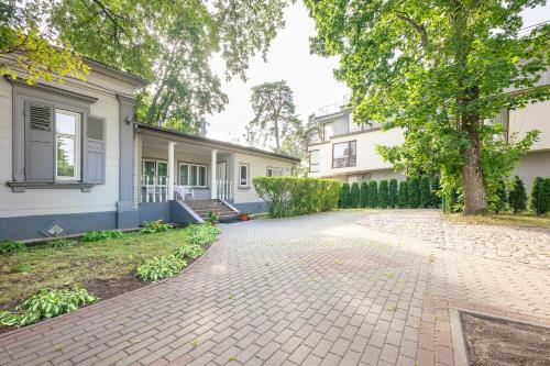 a brick driveway in front of a house at Valensija in Jūrmala