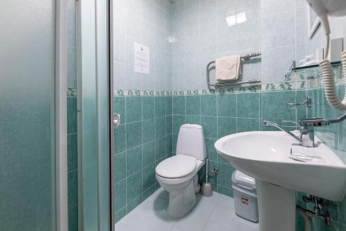a bathroom with a toilet and a sink at Valensija in Jūrmala