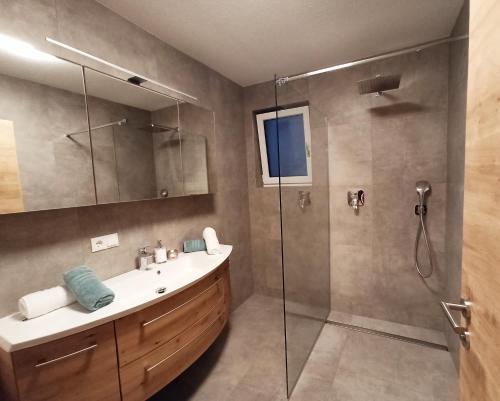 a bathroom with a sink and a shower at The AlpenHouse Gligic´s in Sautens