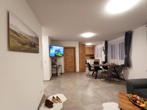 a living room with a table and a dining room at The AlpenHouse Gligic´s in Sautens