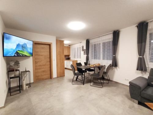 a living room with a dining room table and chairs at The AlpenHouse Gligic´s in Sautens