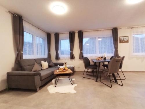 a living room with a couch and a table at The AlpenHouse Gligic´s in Sautens