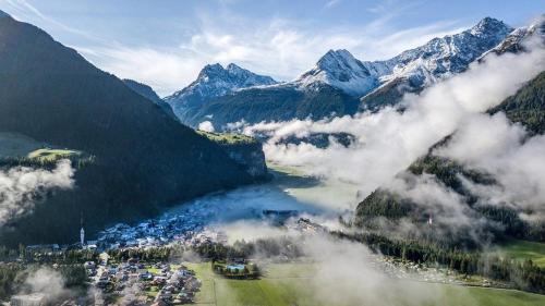 an aerial view of a town in a valley with mountains at The AlpenHouse Gligic´s in Sautens
