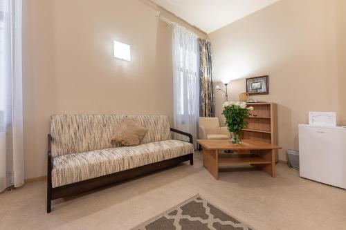 a living room with a couch and a table at Valensija in Jūrmala