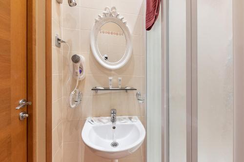 a bathroom with a sink and a mirror at Valensija in Jūrmala