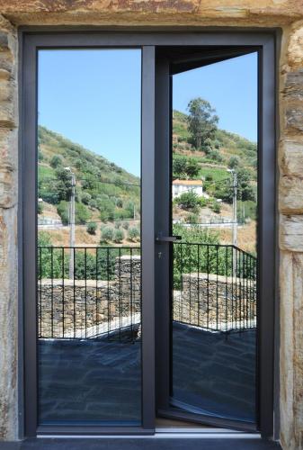 an open door with a view of a mountain at DouroXisto in Peso da Régua