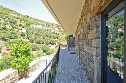 a balcony with a view of a mountain at DouroXisto in Peso da Régua