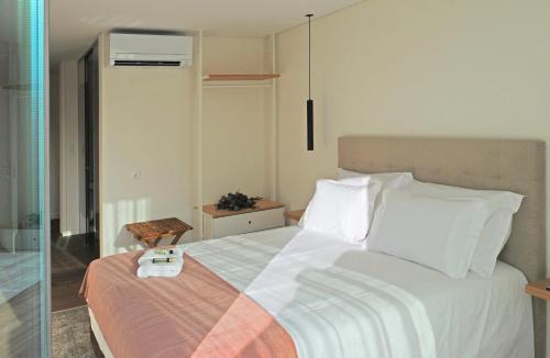 a bedroom with a bed with a thermometer on it at DouroXisto in Peso da Régua