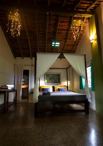 a bedroom with a bed with a canopy at Craft Hostels in Anjuna